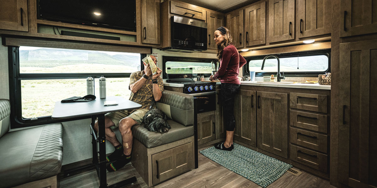 2025 KZ RV Durango HT D232MLD Fifth Wheel with Couple in Kitchen